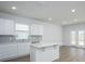 Bright kitchen showcasing an island, ample cabinetry, modern appliances, and a door to the exterior at 740 Meadowbrook Lane, Summerville, SC 29486