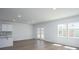 Bright living room features recessed lighting, wood floors, and access to the backyard through glass patio doors at 740 Meadowbrook Lane, Summerville, SC 29486