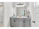 Bathroom featuring double sink vanity with gray cabinets and a large mirror at 7812 Park Gate Dr, North Charleston, SC 29418