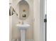 Small bathroom with pedestal sink and an oval mirror at 7812 Park Gate Dr, North Charleston, SC 29418