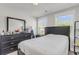 Bright bedroom with a large black framed dresser, mirror and bed at 7812 Park Gate Dr, North Charleston, SC 29418