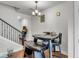 Cozy dining area with wooden floors, modern lighting fixture, and staircase nearby, great for Gathering meals at 7812 Park Gate Dr, North Charleston, SC 29418