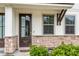Inviting front door with glass panels and stone accents provide an attractive entrance to the townhome at 7812 Park Gate Dr, North Charleston, SC 29418