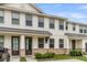Townhome exterior displaying white siding, stone accents, and covered entries with windows offering natural light at 7812 Park Gate Dr, North Charleston, SC 29418