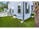 Backyard with a light blue exterior, synthetic grass, and a charming white picket fence at 8604 Bowen Corner Ave, Hanahan, SC 29410