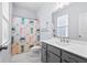 Bright bathroom featuring a white vanity with gray cabinets and a colorful shower curtain at 8604 Bowen Corner Ave, Hanahan, SC 29410