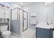 Bathroom with a glass-enclosed shower, vanity, white walls and white tile floors at 8604 Bowen Corner Ave, Hanahan, SC 29410