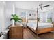 Bright bedroom with a four-poster bed, ceiling fan, and ample natural light at 8604 Bowen Corner Ave, Hanahan, SC 29410