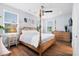 Spacious bedroom with four-poster bed, light walls, ceiling fan and wood floors at 8604 Bowen Corner Ave, Hanahan, SC 29410