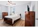 Cozy bedroom with ceiling fan, hardwood floors, and a TV mounted on the wall at 8604 Bowen Corner Ave, Hanahan, SC 29410