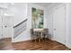 Dining area with a table and chairs situated between a staircase and a doorway with artwork at 8604 Bowen Corner Ave, Hanahan, SC 29410