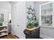 Entryway featuring cabinet storage with decor and decorative shelving adjacent to window and white door at 8604 Bowen Corner Ave, Hanahan, SC 29410