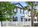 Charming two-story blue home with white picket fence and mature palm trees, creating a welcoming curb appeal at 8604 Bowen Corner Ave, Hanahan, SC 29410