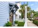 Inviting front entrance featuring a decorative wreath, lush potted plants, and a charming pergola, creating a warm welcome at 8604 Bowen Corner Ave, Hanahan, SC 29410