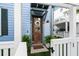 Cozy front entrance with a wooden door, decorative wreath, and potted plants, creating a welcoming atmosphere for guests at 8604 Bowen Corner Ave, Hanahan, SC 29410