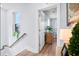 Hallway with natural light, wood floors and a view into another room at 8604 Bowen Corner Ave, Hanahan, SC 29410