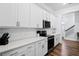 Bright white kitchen features stainless steel appliances, quartz countertops and white cabinetry at 8604 Bowen Corner Ave, Hanahan, SC 29410