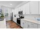Bright white kitchen featuring stainless steel appliances, white cabinets, and an adjacent window at 8604 Bowen Corner Ave, Hanahan, SC 29410