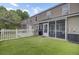 The backyard features a screened porch, a white fence, and lush green grass at 1005 Washitonia Way # B, Charleston, SC 29492