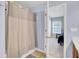 This bathroom has a shower and tub combination with a light beige shower curtain at 1005 Washitonia Way # B, Charleston, SC 29492