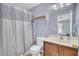 This bathroom features neutral paint, shower/tub, single sink vanity, and a neutral shower curtain at 1005 Washitonia Way # B, Charleston, SC 29492