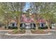 The community clubhouse has a red roof and gray siding, framed by trees and landscaping at 1005 Washitonia Way # B, Charleston, SC 29492