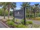 Elegant entrance sign to The Peninsula, featuring palm trees and manicured landscaping at 1005 Washitonia Way # B, Charleston, SC 29492