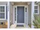 Inviting front entrance with a dark blue door, decorative sidelights, and charming 'Hey Friends' sign at 1005 Washitonia Way # B, Charleston, SC 29492