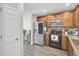 Well-equipped kitchen with stainless steel appliances, classic wood cabinets, and a brick backsplash, blending style and functionality at 1005 Washitonia Way # B, Charleston, SC 29492