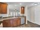 An open kitchen with wood cabinets and stainless steel appliances provides a welcoming space at 1005 Washitonia Way # B, Charleston, SC 29492