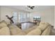 Cozy living room with large sectional, ceiling fan, and natural light shining through the patio doors at 1005 Washitonia Way # B, Charleston, SC 29492
