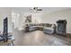 Open concept living room with modern gray sectional, ceiling fan, and wood floors at 1005 Washitonia Way # B, Charleston, SC 29492