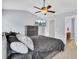 This main bedroom features light blue walls, a ceiling fan, and an ensuite bathroom entrance at 1005 Washitonia Way # B, Charleston, SC 29492