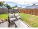 Spacious backyard with green grass, wooden fence, and patio seating for relaxation and entertainment at 102 Jasimine Ct, Summerville, SC 29486