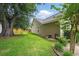 Large backyard with mature tree, green lawn, and privacy fence at 105 Corral Cir, Summerville, SC 29485