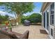 Charming backyard patio with grill, beautiful landscaping, and sliding glass doors, ideal for outdoor living at 105 Corral Cir, Summerville, SC 29485