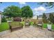 Inviting backyard patio featuring wicker furniture and lush landscaping, perfect for outdoor relaxation and entertaining at 105 Corral Cir, Summerville, SC 29485