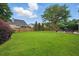 Spacious backyard with mature trees and a wooden privacy fence at 105 Corral Cir, Summerville, SC 29485
