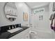 Bright bathroom featuring a modern vanity, tub with shower, and stylish black and white mosaic tile floor at 105 Corral Cir, Summerville, SC 29485