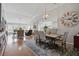 Open-concept dining room with hardwood floors and views of the living room and kitchen at 105 Corral Cir, Summerville, SC 29485