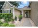 Inviting entrance with stone walkway, potted plants, and manicured shrubs at 105 Corral Cir, Summerville, SC 29485