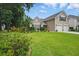 Charming home featuring a lush green lawn and mature landscaping at 105 Corral Cir, Summerville, SC 29485