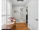 Inviting hallway with hardwood floors, shuttered window, and glimpse into the bathroom, providing warmth and character at 105 Corral Cir, Summerville, SC 29485