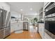 Open kitchen featuring stainless steel appliances, white cabinets, and hardwood floors at 105 Corral Cir, Summerville, SC 29485