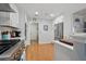 Modern kitchen with stainless steel appliances, white cabinetry, and hardwood flooring, offering a stylish and functional space at 105 Corral Cir, Summerville, SC 29485