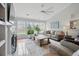 Bright living room with large windows, hardwood floors, and neutral decor, creating a cozy atmosphere at 105 Corral Cir, Summerville, SC 29485