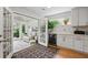 Sunroom with tile floors, white cabinets, and view to the kitchen at 105 Corral Cir, Summerville, SC 29485