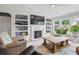 Cozy living room featuring a fireplace, built-in shelves, and natural light, perfect for relaxation and entertainment at 105 Corral Cir, Summerville, SC 29485