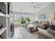 Bright living room with large windows, hardwood floors, and neutral decor, creating a cozy atmosphere at 105 Corral Cir, Summerville, SC 29485