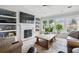 Bright living room with a fireplace, built-in shelves and a large window for natural light at 105 Corral Cir, Summerville, SC 29485